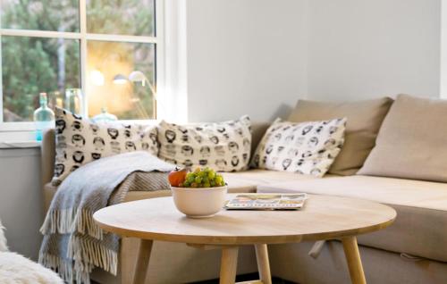 a living room with a couch and a table with a bowl of fruit at 2 Bedroom Nice Home In Nykøbing Sj in Nyrup