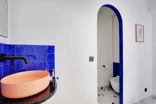 a bathroom with a bath tub and a toilet at Super colourful studio in the heart of the 18th arrondissement in Paris
