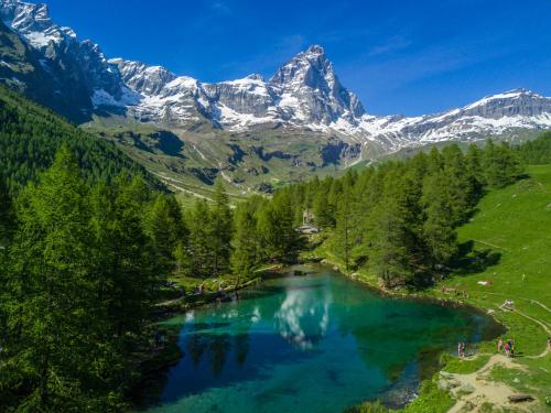 an aerial view of a lake with mountains in the background at Chalet Matterhorn Francois - Central Ski Chalet with SPA and Breakfast, 100mt lift in Breuil-Cervinia