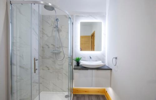 a bathroom with a shower and a sink at The Hideaway At The Lawrence Apartments in York