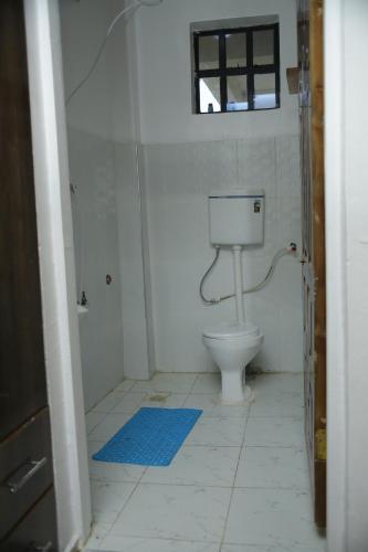 a bathroom with a toilet and a window at Enn lovely apartment 10 in Bungoma