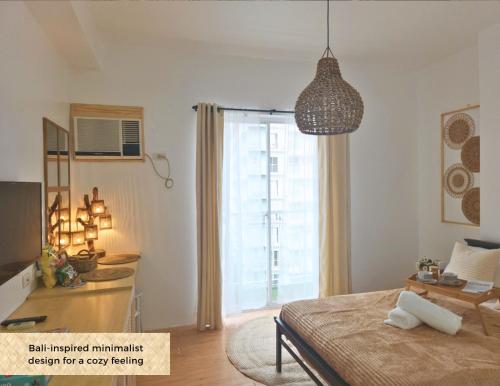 a bedroom with a bed and a pendant light at The Traveller's Haven Airbnb in Cebu City