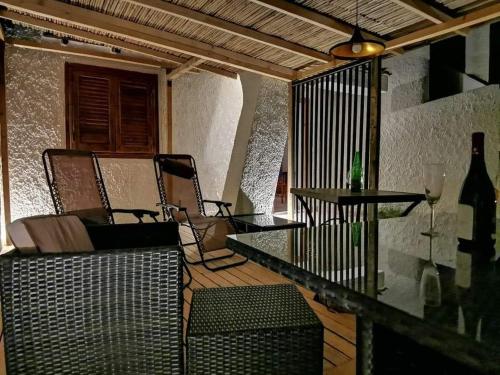 a patio with two chairs and a glass table at Villa Oasi dune e mare in Campobello di Mazara