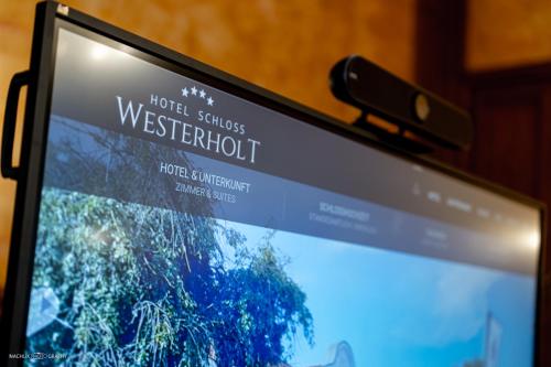 a computer monitor with a website on the screen at Schlosshotel Westerholt in Herten