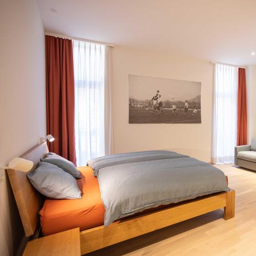 a bedroom with a bed with an orange bedspread at Locanda della Masseria a Porza, Lugano in Porza