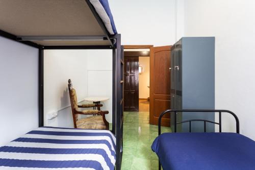 San Juan de la Rambla的住宿－El Hostal del Cubo，一间卧室配有一张双层床和一张桌子