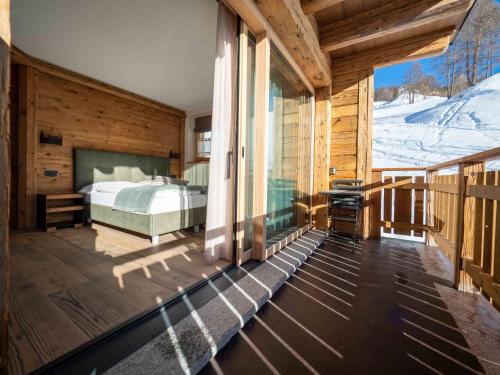 a bedroom with a bed on a balcony at Deschana Lodge in Livigno