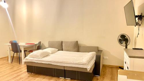 a bed in a room with a table and a couch at Kastanimaja Apartments in Tartu