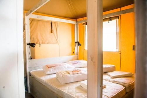 a bedroom with three bunk beds in a room at Cottage de Luxe in Harderwijk