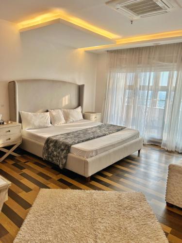 a bedroom with a large bed and a large window at Gold crest Mall, The Aesthetic one bed suite in Lahore