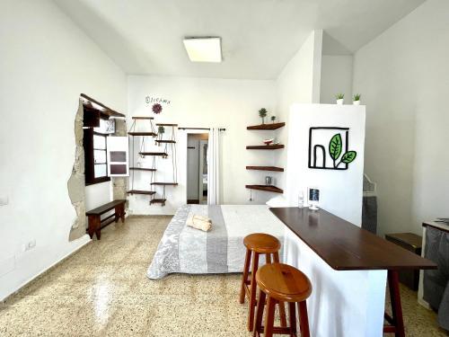 a kitchen with a bed and a table and chairs at El Hostal del Cubo in San Juan de la Rambla