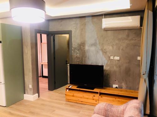 a living room with a flat screen tv at Bohemian Residence in Kérynia