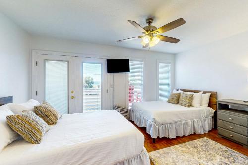 a bedroom with two beds and a ceiling fan at The Red Rocker in Highland View