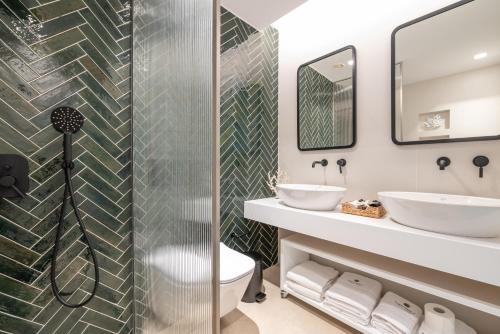 a bathroom with two sinks and a shower at Porto Perla in Kos Town