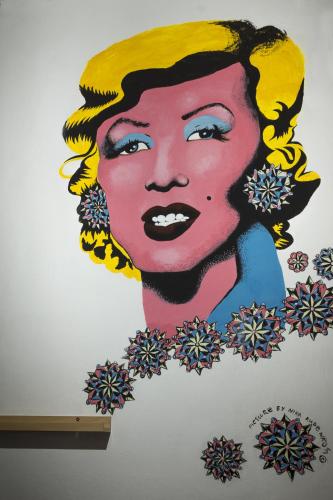 a painting of a woman on a wall at Hostel Lollis Homestay Dresden in Dresden