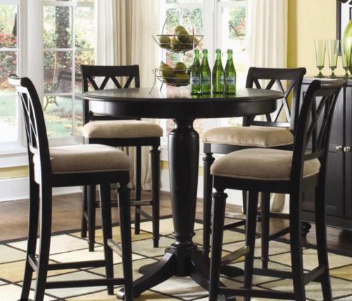 a black dining room table with chairs and bottles of wine at Apartment in Amman 7th circle in Amman