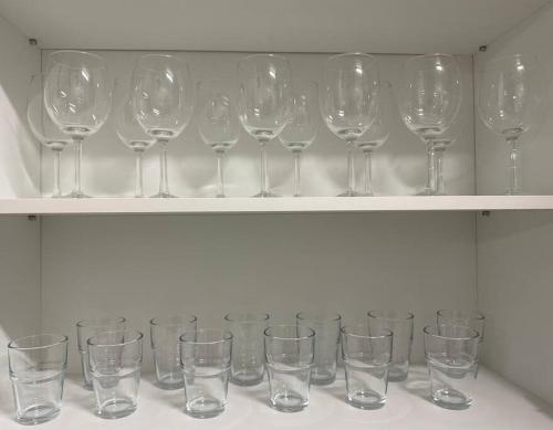 a row of empty wine glasses sitting on a shelf at Seoul center new Sindang station in Seoul