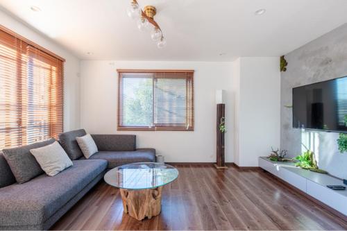a living room with a couch and a table at Residencial Voyan 南砂町 in Tokyo