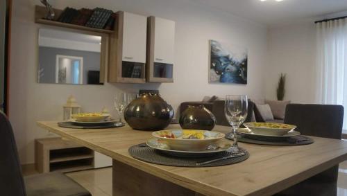a dining room table with bowls of food and wine glasses at Chrysa's Luxury Apt. View of Palamidi in Nafplio