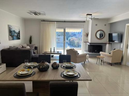 a living room with a table and a couch at Chrysa's Luxury Apt. View of Palamidi in Nafplio