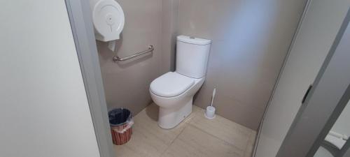 a small bathroom with a toilet in a stall at Scorpius Hostel in Vicuña