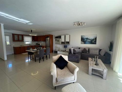 a living room with a couch and a table at Chrysa's Luxury Apt. View of Palamidi in Nafplio