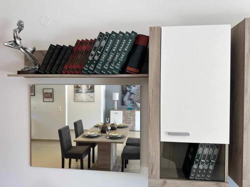 a reflection of a living room with a table and chairs at Chrysa's Luxury Apt. View of Palamidi in Nafplio