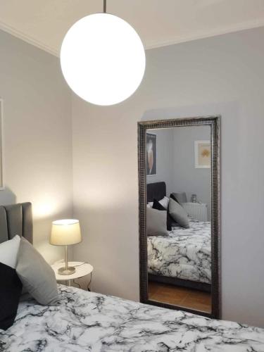 a bedroom with a large mirror and a bed at Chrysa's Luxury Apt. View of Palamidi in Nafplio