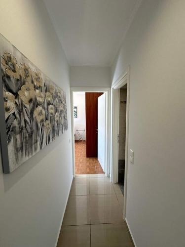 a hallway with a painting on a white wall at Chrysa's Luxury Apt. View of Palamidi in Nafplio