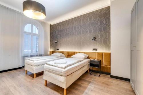 Postel nebo postele na pokoji v ubytování Apartamenty Mickiewicza - Superior Suites Katowice