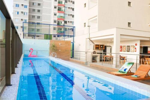 a large swimming pool with chairs in a building at Mar & Descanso Itaparica in Vila Velha