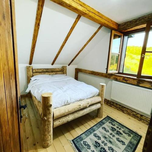 a bedroom with a bed in a room with windows at Cuibul cu Trufe in Feldru
