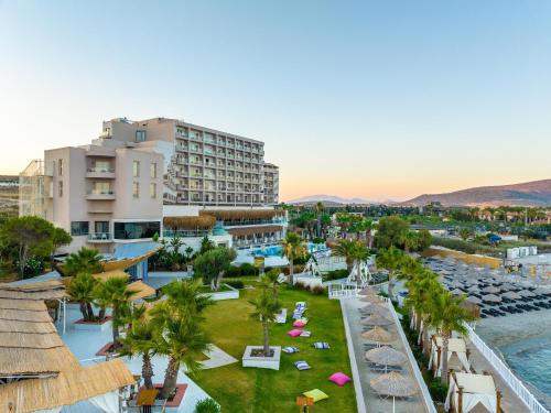 an aerial view of a resort with palm trees at Design Plus Seya Beach Hotel in Alacati