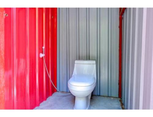 a bathroom with a white toilet in a stall at Aqua Splash Camp, Rishikesh in Rishīkesh
