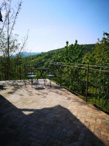 a patio with a table and a fence with a view at [Suite Elicriso] in Varzi