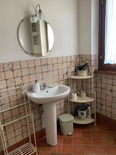 a bathroom with a sink and a mirror at [Suite Elicriso] in Varzi