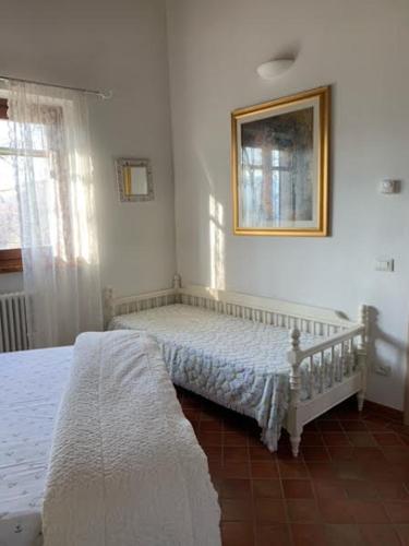 a bedroom with a bed and a picture on the wall at [Suite Elicriso] in Varzi