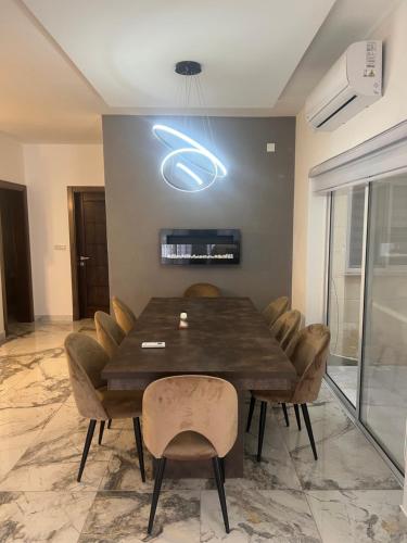 a dining room with a wooden table and chairs at Palm Haven - Boutique Gozo Maisonette in Munxar
