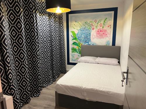 a bedroom with a bed and a painting on the wall at 3 bedroom house Colchester in Colchester