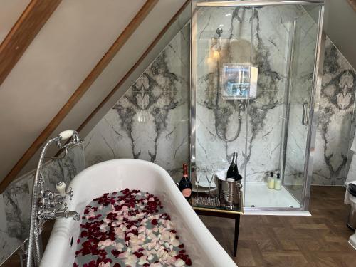 a bathroom with a bath tub filled with confetti at Old Town House by Ezestays in Margate