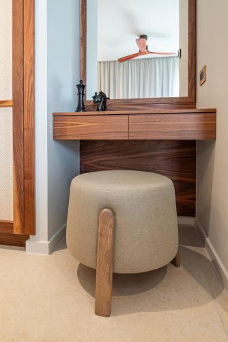a chair in front of a desk with a mirror at Porto Perla in Kos Town