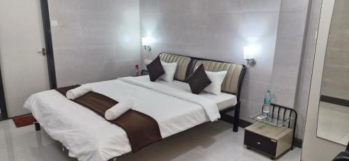 a bedroom with a large bed with white sheets and pillows at Tony's Inn Baga Apartment in Baga