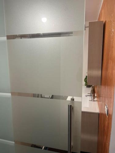 a white kitchen with a refrigerator in a room at Casetta San Donato in Turin