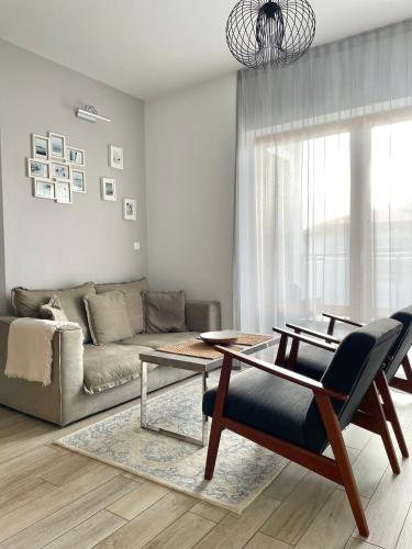 a living room with a couch and a table at Baltic Sands in Hel