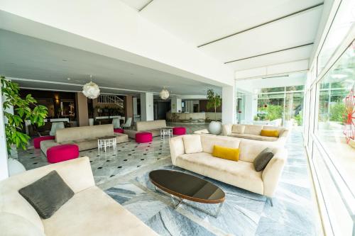 a living room with two couches and a table at Golden Tulip Président Hammamet in Hammamet