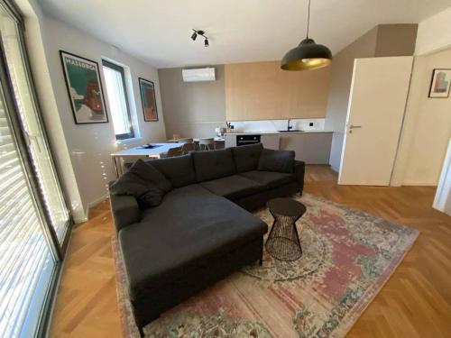 a living room with a couch and a kitchen at Bratislava FORESTPARK, FREE parking, self-check IN in Bratislava