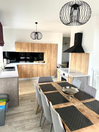 a kitchen and dining room with a table and chairs at Baltic Sands in Hel