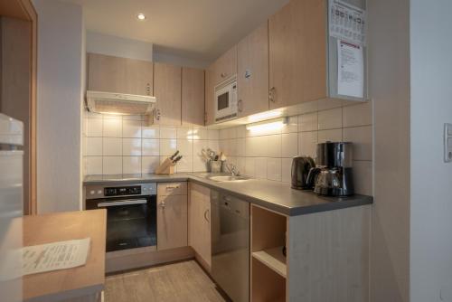 a small kitchen with a sink and a stove at Petit Madlein in Ischgl