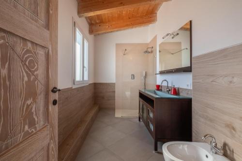 a bathroom with a sink and a mirror at Dimoras Dimore Esclusive in Olbia
