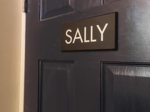 a black door with the words ally written on it at Sally in Whitstable